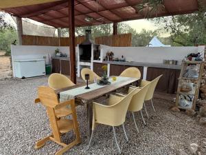 a wooden table and chairs in a kitchen at Bellissima Bell Tent - Romantic Glamping Retreat in Nature in Tortosa
