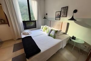 a bedroom with a large white bed and a window at Hotel Residence in Rio de Janeiro