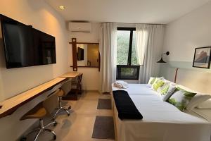 a hotel room with two beds and a tv on the wall at Hotel Residence in Rio de Janeiro