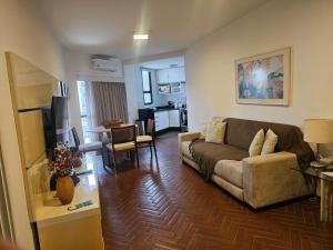 a living room with a couch and a kitchen at Hotel Residence in Rio de Janeiro