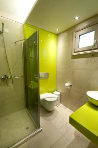 a bathroom with a shower and a toilet and a sink at Louloudis Fresh-Adults Only in Skala Rachoniou