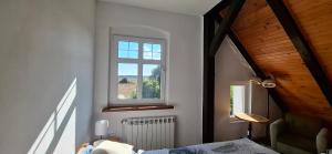 a bedroom with a bed and a window and a radiator at KAM-TECH Krzysztof Kamiński in Krzywy Róg