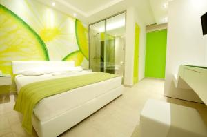 a bedroom with a bed with a painting on the wall at Louloudis Fresh-Adults Only in Skala Rachoniou