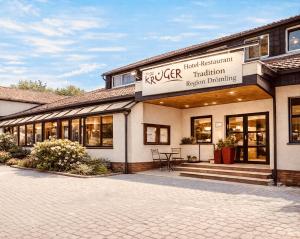 a building with a sign that reads kcr treatment revision planning at Hotel-Restaurant Krüger in Grafhorst