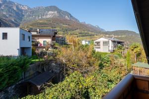 a view from a balcony of houses and mountains at Apartments Burgunderhof in Termeno
