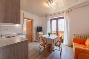 a kitchen and living room with a table and a kitchen and a dining room at Apartments Burgunderhof in Termeno +102 photos