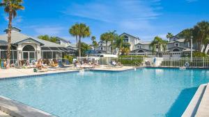a pool at a resort with people sitting on the beach at Spacious 3BR Siesta Key condo with private beach access in Siesta Key
