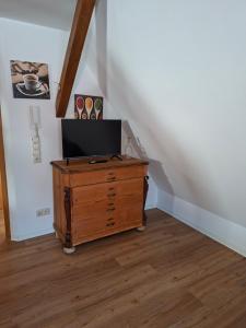 a wooden dresser with a television on top of it at Ferienwohnung HEIDI in Donauwörth