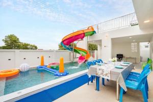 a house with a pool with a water slide at Good Pool Villa Luxury in Ban Hui Yai Muk