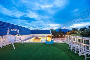 a balcony with a swing and a playground at Good Pool Villa Luxury in Ban Hui Yai Muk
