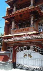 a building with a gate in front of it at Ratih Bali Hostel in Denpasar