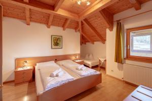 a bedroom with a bed and a window at Apartments Haus Weinberg in Caldaro +64 photos