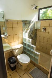 a bathroom with a toilet and a sink and a shower at Hotel Manuel Antonio Beracha in Quepos +35 photos