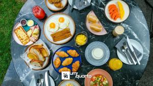 a group of plates of breakfast foods on a table at Heron Marinho Flats in Campina Grande