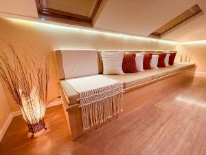 a couch in a room with pillows on it at Sea Paradise Hospedagem in Fernando de Noronha