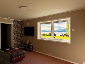 a room with a large window with a view at Nordic Sauna Retreat in Tromsø