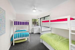 a room with two bunk beds and a window at BYO Linen - Aireys Delight in Aireys Inlet