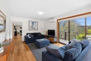 a living room with a couch and a tv at BeachHaven in Aireys Inlet