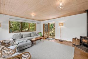 a living room with a couch and a table at Atwood in Aireys Inlet