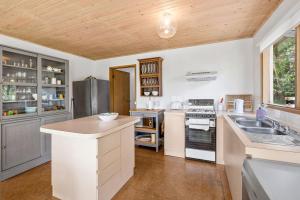 a kitchen with a sink and a stove top oven at Atwood in Aireys Inlet