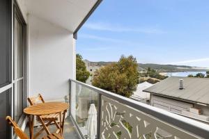 a balcony with a table and chairs and a view of the ocean at Bay View Motel - Sunrise in Lorne