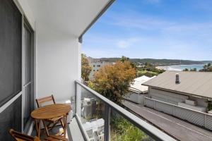 a balcony with a table and chairs and a view at Bay View Motel - Sunrise in Lorne +3 photos