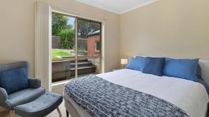 a bedroom with a bed and a chair and a window at Majestic Views in Marengo +14 photos