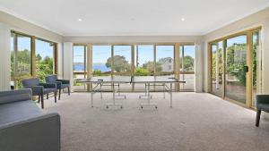 a living room with a table and chairs and windows at Majestic Views in Marengo