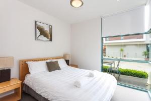 a bedroom with a bed and a large window at Anglesea River Apartment 23 in Anglesea
