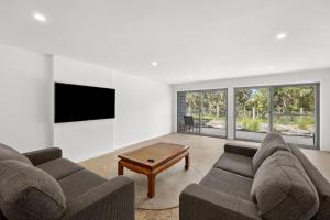 a living room with two couches and a coffee table at Aireys Sunset Beach House in Aireys Inlet