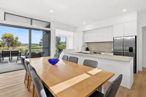 a kitchen and dining room with a wooden table with chairs at Aireys Sunset Beach House in Aireys Inlet +9 photos