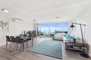 a living room with a table and a couch at Point Grey Apartment 13 in Lorne