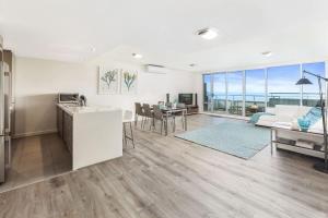 a kitchen and living room with a kitchen and a living room at Point Grey Apartment 13 in Lorne