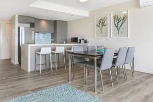 a kitchen and dining room with a table and chairs at Point Grey Apartment 13 in Lorne +7 photos