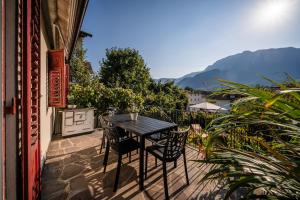 a table and chairs on the balcony of a building at Villetta Allegra in Appiano sulla Strada del Vino