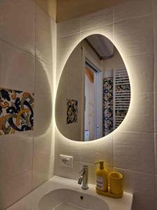 a bathroom with a sink and a mirror at La Corte dell'Angelo Rooms - Guest House in Orio al Serio