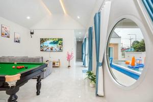 a living room with a pool table and a mirror at Good Pool Villa Luxury in Ban Hui Yai Muk