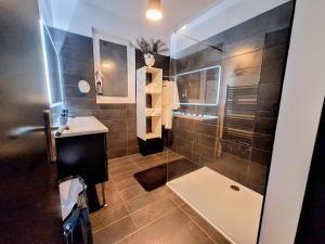 a bathroom with a shower and a sink at L'antre Parenthèse 46 in Souillac +15 photos