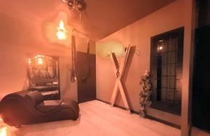 a room with a chair and a large x on the wall at L'antre Parenthèse 46 in Souillac