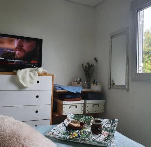 a bedroom with a dresser with a tv and a bed at La Constancia in Parana