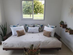 a bed with pillows and a window in a room at La Constancia in Parana +18 photos