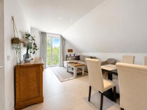 a living room with a table and a dining room at Oceanview Residences Lauterbach Rügen Ostsee erste Reihe in Putbus