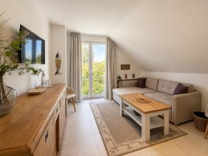 a living room with a couch and a table at Oceanview Residences Lauterbach Rügen Ostsee erste Reihe in Putbus