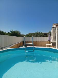 a chair sitting in a swimming pool at Monte do Ti'Mota in São Lourenço de Mamporcão +13 photos