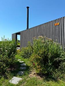 a building with a sign on the side of it at 102 Tiny House in erster Reihe mit Kamin & Blick ins Grüne in Bleckede