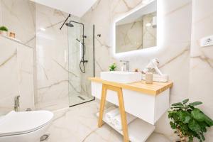 a bathroom with a sink and a shower at Green Terrace Square View in Tirana +25 photos