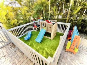 a toy sandbox with a play set on the grass at Family Tides in Holmes Beach +159 photos