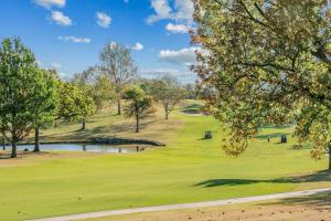 a view of a golf course with a pond and trees at WorldMark Grand Lake in Monkey Island