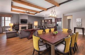a dining room and living room with a table and chairs at Club Wyndham Park City in Park City