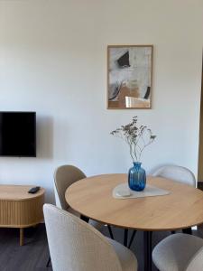 a room with two tables with chairs and a vase with flowers at Cozy Apartment with Castle view in Staré Mesto